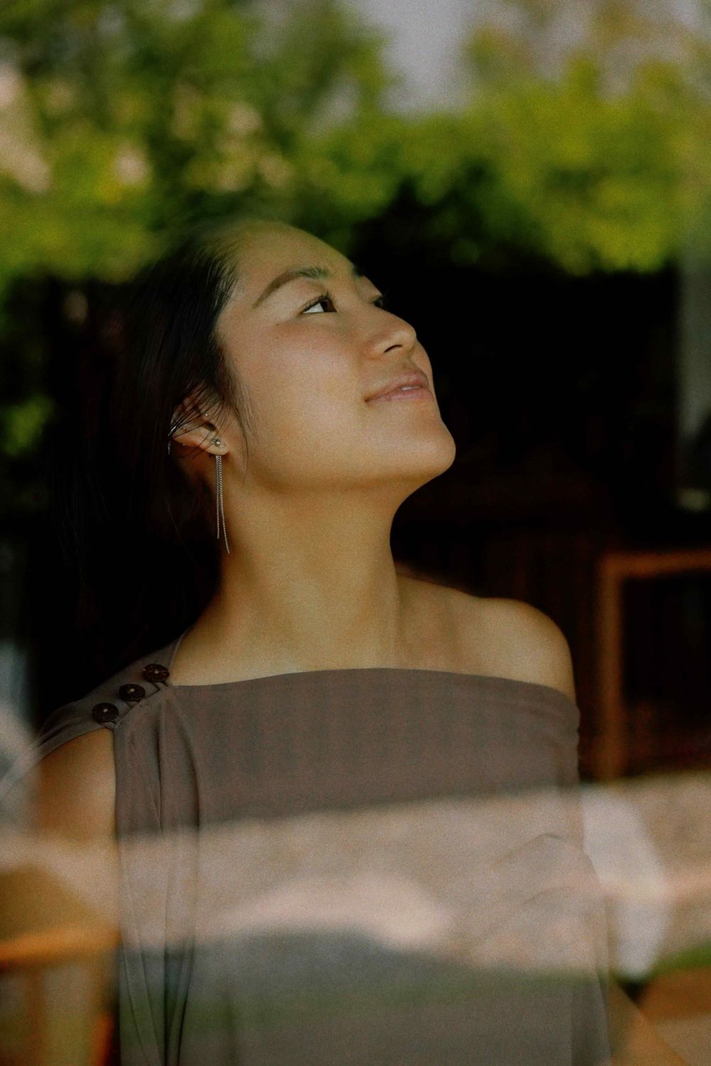 Yukino looking up through a window, smiling